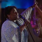 Worship singer holding Sennheiser microphone