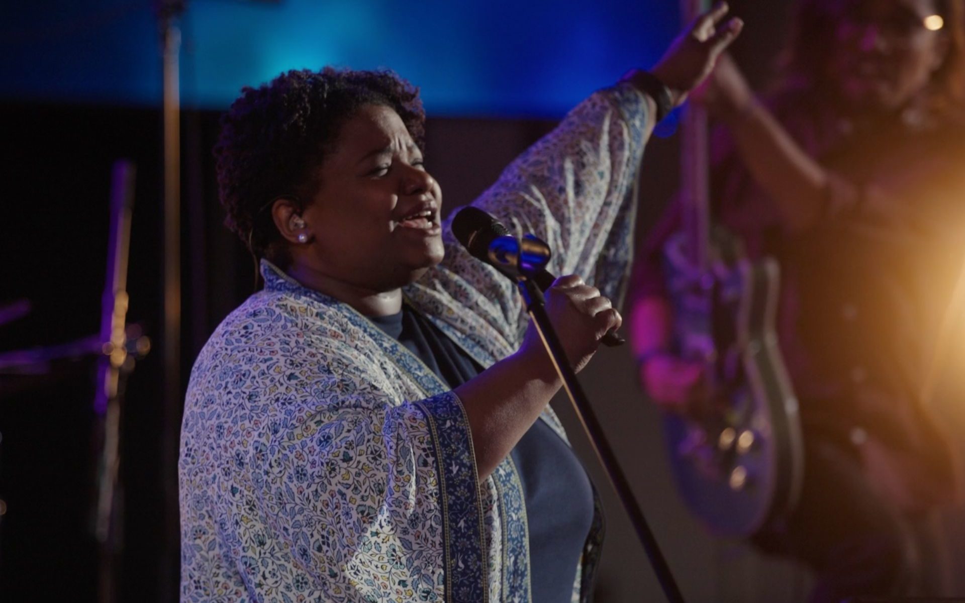 Worship singer holding Sennheiser microphone