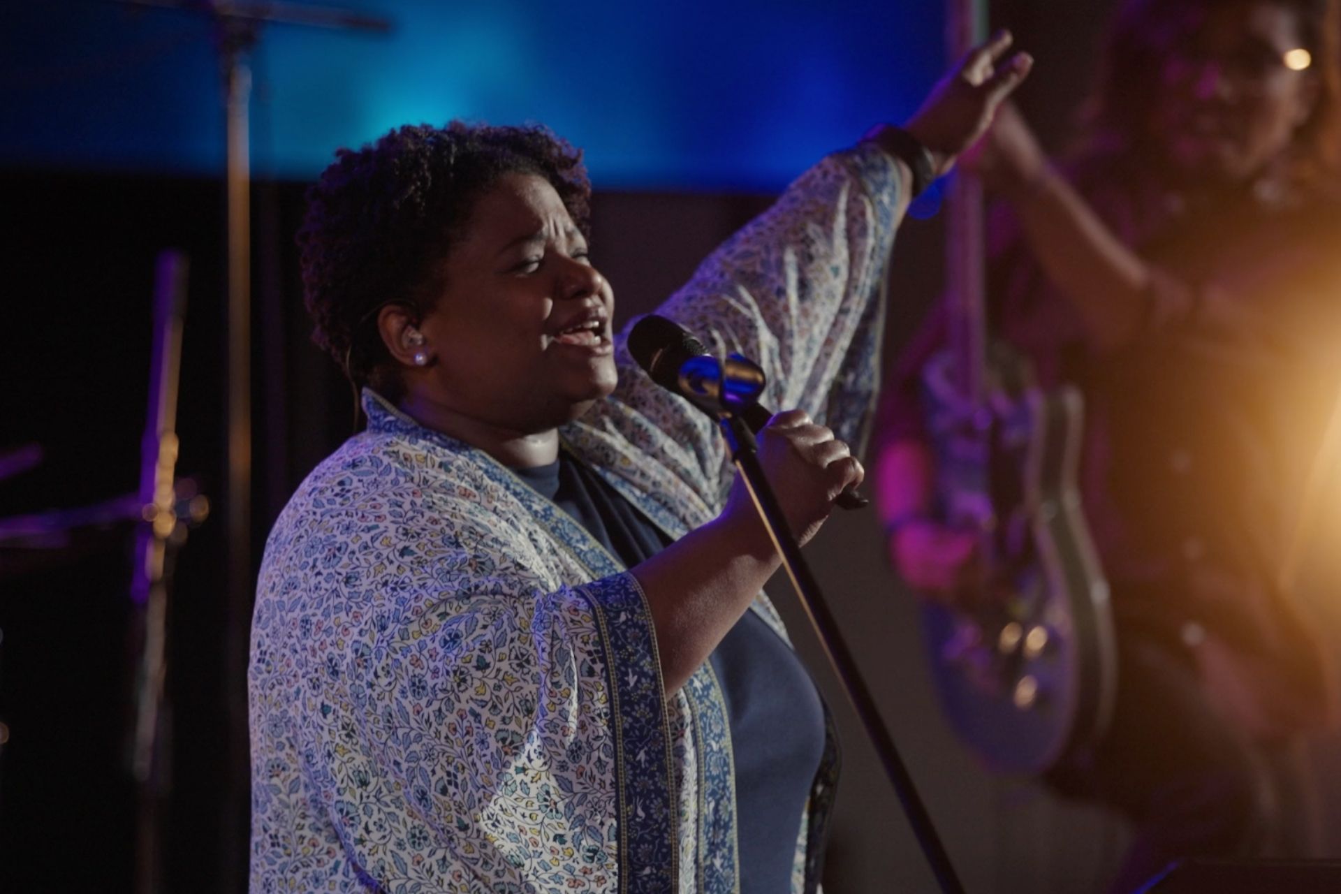 Worship singer holding Sennheiser microphone